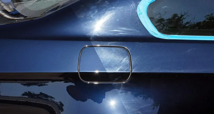 a blue car with half paint corrected with no scratches and the other half full of scratches
